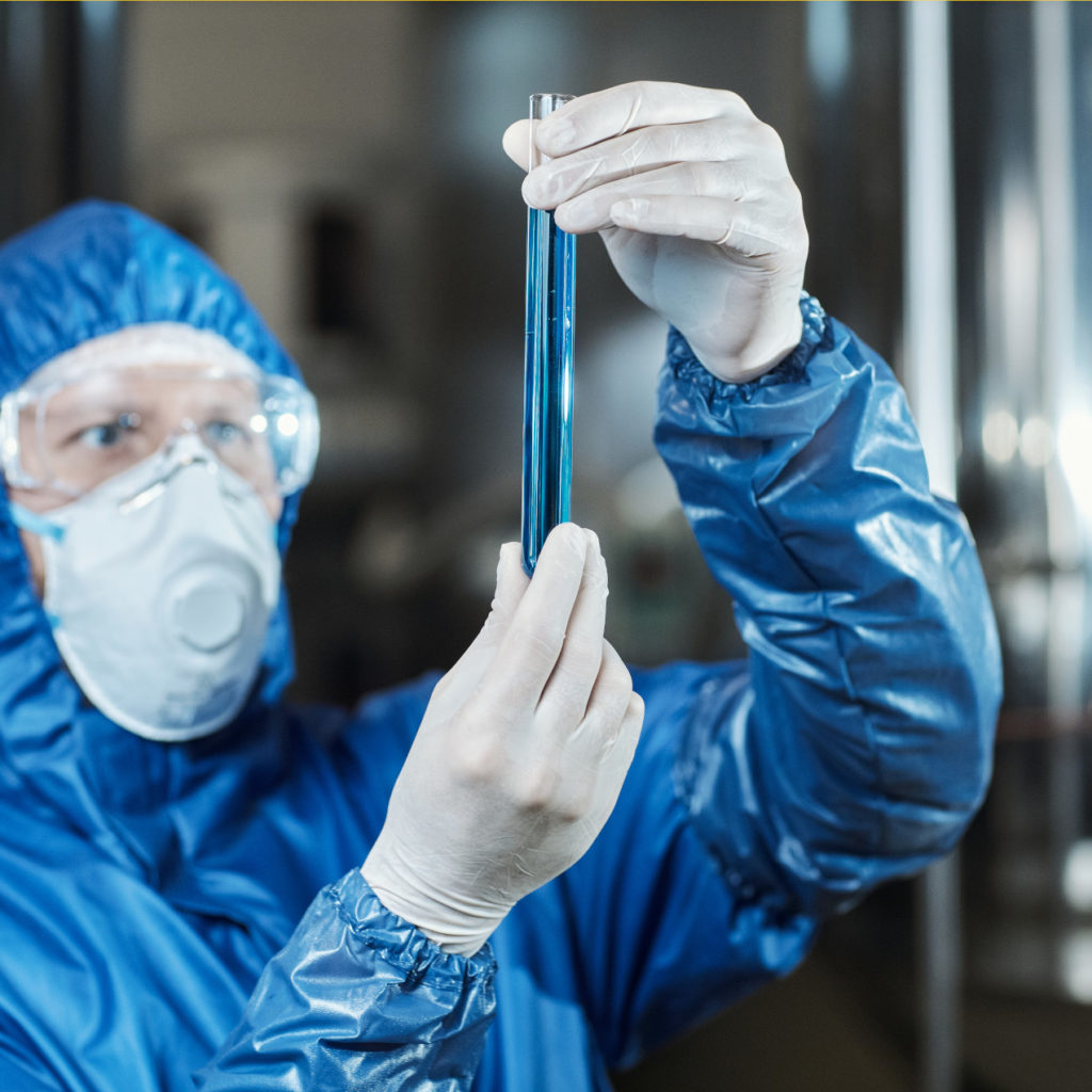 worker-holding-test-tube-with-blue-liquid-at-chemi-2023-02-16-16-11-33-utc